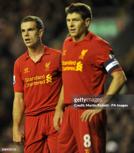 Liverpool's Jordan Henderson stands next to teammate Steven Gerrard
