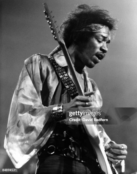 American rock guitarist and singer Jimi Hendrix performs live on stage playing a white Fender Stratocaster guitar with The Jimi Hendrix Experience at...