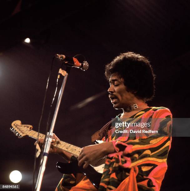 American rock guitarist and singer Jimi Hendrix performs live on stage playing a black Fender Stratocaster guitar at the 1970 Isle of Wight Festival...