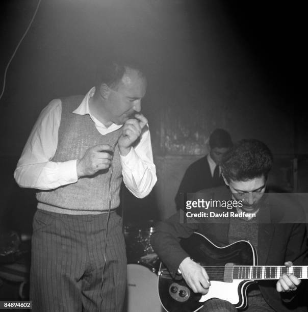 British blues guitarist Alexis Korner performs live on stage with Cyril Davies and drummer Charlie Watts at Ealing Jazz Club in Ealing, London in...