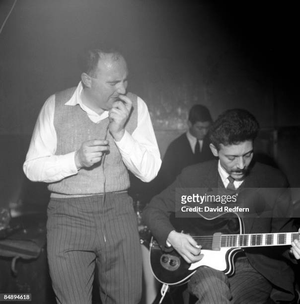 British blues guitarist Alexis Korner performs live on stage with Cyril Davies and drummer Charlie Watts at Ealing Jazz Club in Ealing, London in...