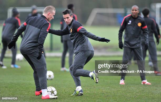 Manchester United's Robin Van Persie and Alexander Buttner during a training session at Carrington Training Ground, Manchester.