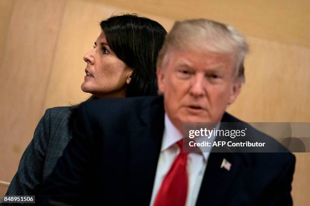 Ambassador to the UN Nikki Haley and US President Donald Trump wait for a a meeting on United Nations Reform at UN headquarters in New York on...