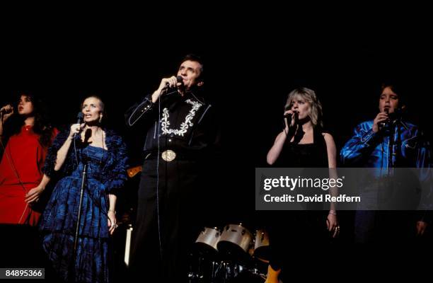 Photo of Carlene CARTER and June CARTER and Johnny CASH; Johnny Cash performing on stage with The Carter Family, includine June Carter and Carlene...