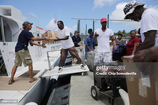 Crew and volunteers load the Queen Elizabeth IV ferry with supplies and passengers for St. Thomas more than a week after Hurricane Irma made landfall...