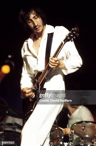 English guitarist Pete Townshend, wearing his trademark white boiler suit, performs live on stage playing a Gibson SG Special guitar, with rock group...