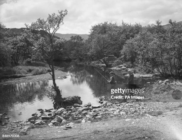 David Parker of Wakefield, West Yorkshire, fishes on the banks of the River Rothay, which flows from Grasmere to Rydal Water in Westmorland.