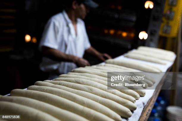Worker makes canillas, banquette-like bread popular in the country for decades, at a bakery in Caracas, Venezuela, on Wednesday, Aug. 30, 2017. The...