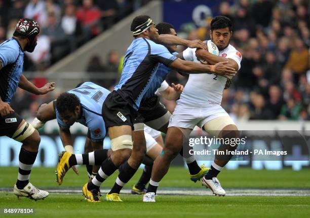 England's Manusamoa Tuilagi is tackled by Fiji's Vereniki Goneva during the QBE International match at Twickenham Stadium, Twickenham.