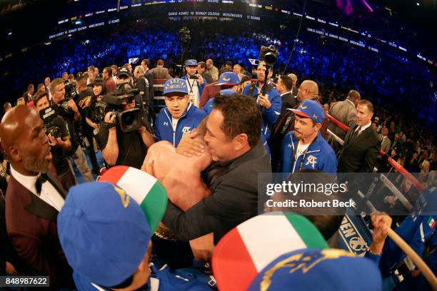 Middleweight Title: Canelo Alvarez hugging promoter Oscar De La Hoya after fight vs Gennady Golovkin at T-Mobile Arena. Las Vegas, NV 9/16/2017...