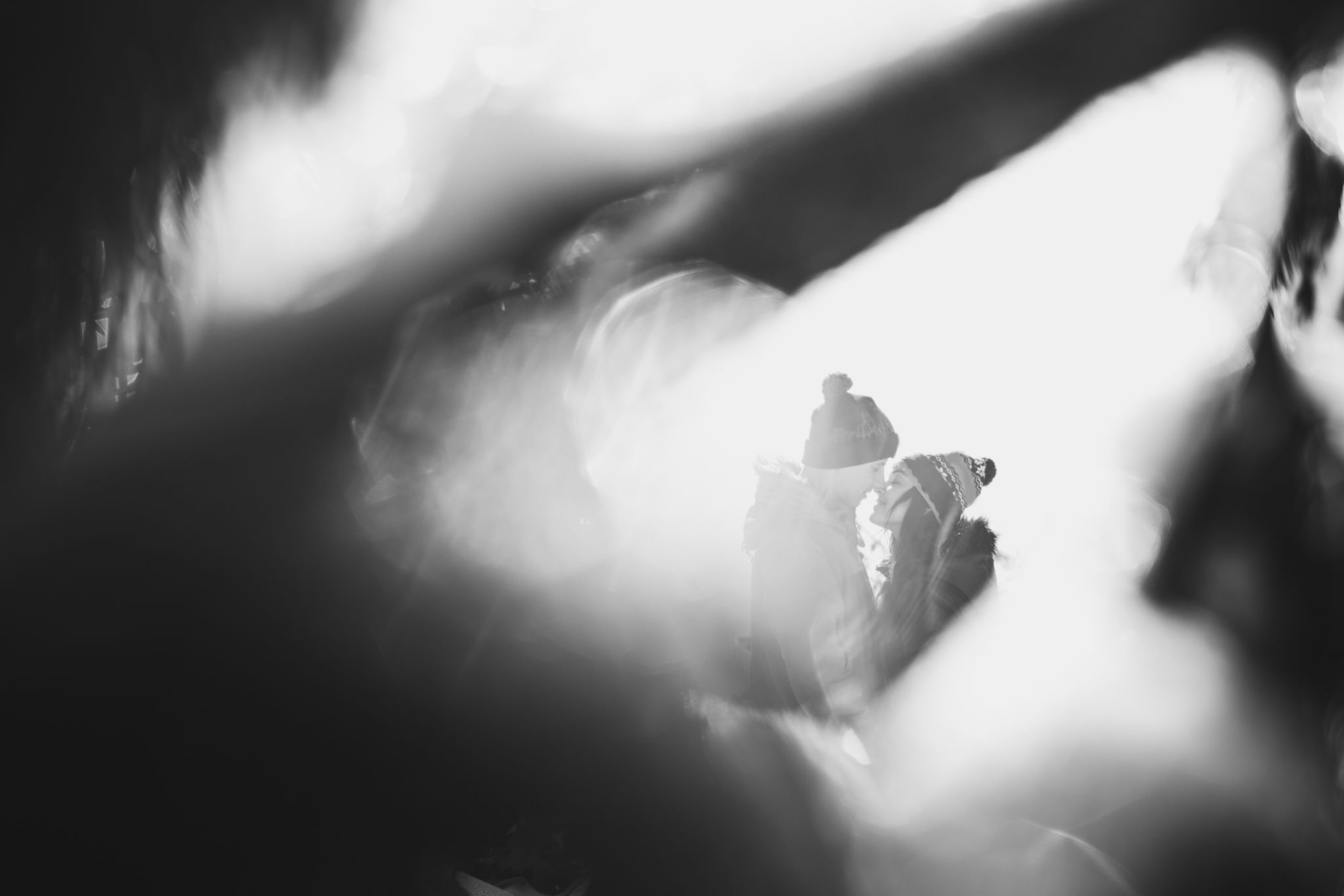 Close and emotional portrait of loving couple at winter. Through flickering bokeh Close and emotional portrait of loving couple at winter. Through flickering bokeh