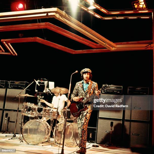 Drummer Keith Moon and guitarist Pete Townshend, dressed as a pearly king and playing a Gibson SG Special guitar, perform on stage with English rock...