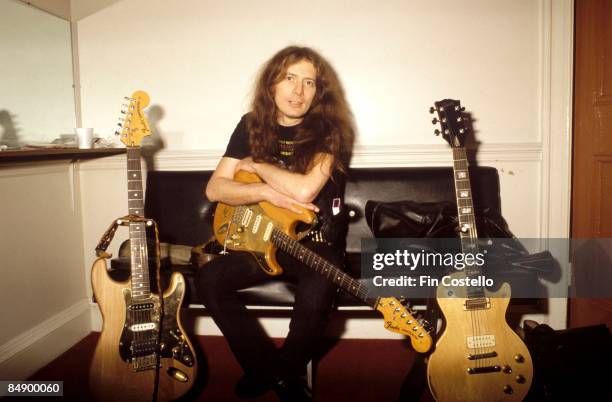 Photo of MOTORHEAD; Portrait of Fast Eddie Clark backstage with guitars, circa 1980.