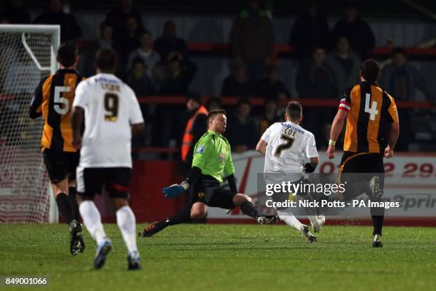 Leyton Orient's Dean Cox scores the second goal beating Gloucester City goalkeeper Mike Green during the FA Cup First Round match at Whaddon Road,...