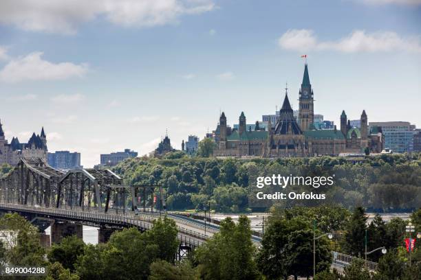 view of parliament hill from ottawa river, canada - quebec parliament stock pictures, royalty-free photos & images