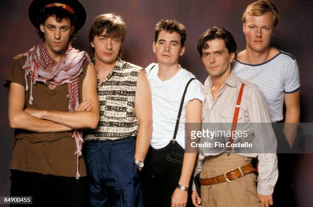 Photo of Simon CROWE and Bob GELDOF and BOOMTOWN RATS and Garry ROBERTS and Johnnie FINGERS and Pete BRIQUETTE; Posed studio group portrait L-R Bob...