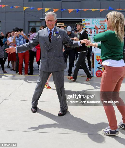 The Prince of Wales, dances with Lisa Shannon from Christchurch during a visit to the Dance O Mat, in the centre of the capital in New Zealand. The...