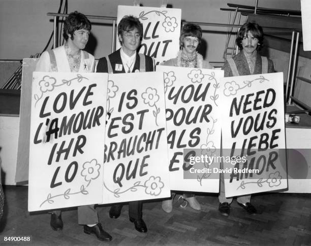 From left, Paul McCartney, John Lennon, Ringo Starr and George Harrison of English rock and pop group The Beatles pose with sandwich boards during a...