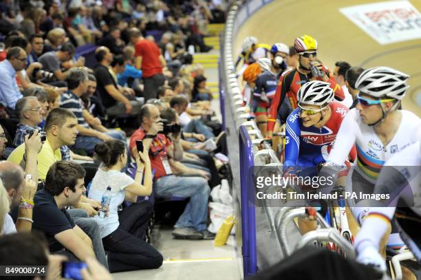 Great Britain's Jonathan Dibben chats with the crowd while World Champion Glenn O'Shea watches before he starts the omnium 30km points race during...