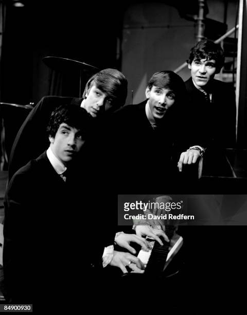 Photo of Tony CRANE and MERSEYBEATS and Billy KINSLEY and Aaron WILLIAMS and John BANKS; Posed group portrait at piano - L-R Tony Crane, John Banks,...