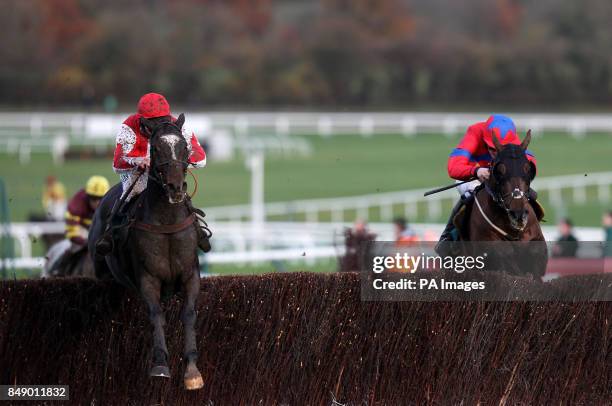 Monbeg Dude ridden by Jamie Moore jumps the last on the way to winning The Henrietta Knight handicap steeple chase during the Paddy Power Gold Cup...