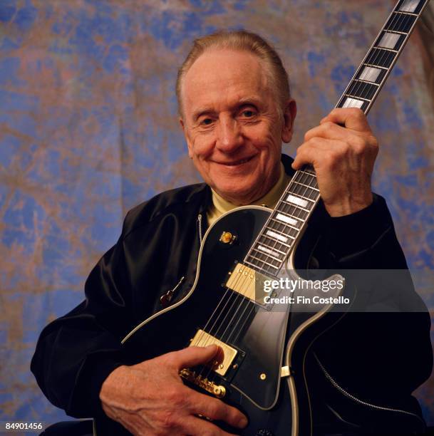Photo of Les PAUL; Posed studio portrait of Les Paul, with Gibson guitar