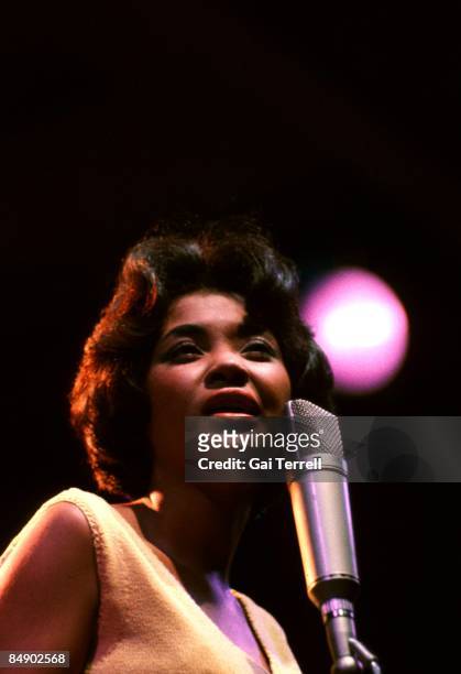 Nancy Wilson, U.S. Jazz singer, in concert, singing into a microphone, circa 1965.