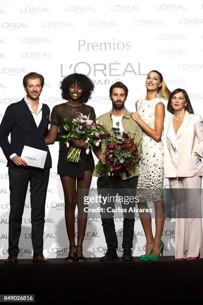 Model Aya Gueye and designer Juan Vidal receive the L'Oreal Paris Award from L'Oreal Paris Brand General Manager Gregory Recoing , model Laura...