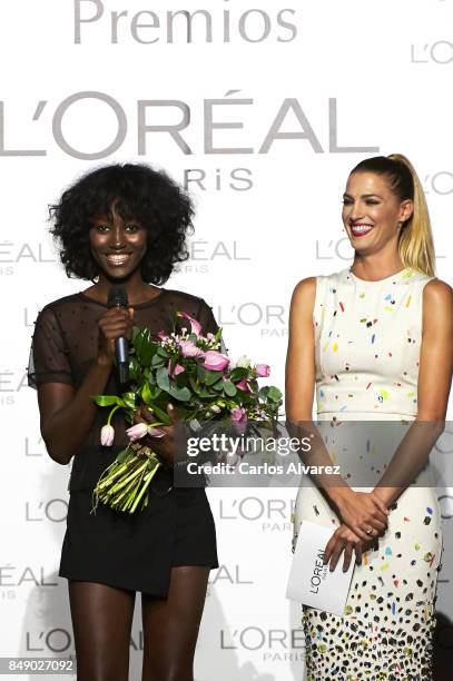 Model Aya Gueye receives the L'Oreal Paris Award from Spanish model Laura Sanchez during the Mercedes-Benz Fashion Week Madrid Spring/Summer 2018 at...