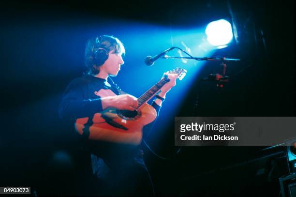 Photo of Roger WATERS and PINK FLOYD, Roger Waters performing live onstage, playing Ovation acoustic guitar, wearing headphones, on In The Flesh tour
