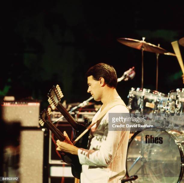 Photo of John McLAUGHLIN and MAHAVISHNU ORCHESTRA, John McLaughlin performing on stage, twin necked guitar