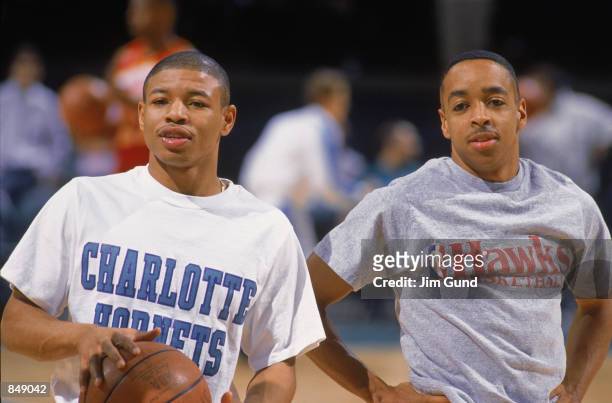 Mugsy Bogues of the Charlotte Hornets stands on the court with Spud Webb of the Atlanta Hawks before an NBA game at Charlotte Colesium in 1989.