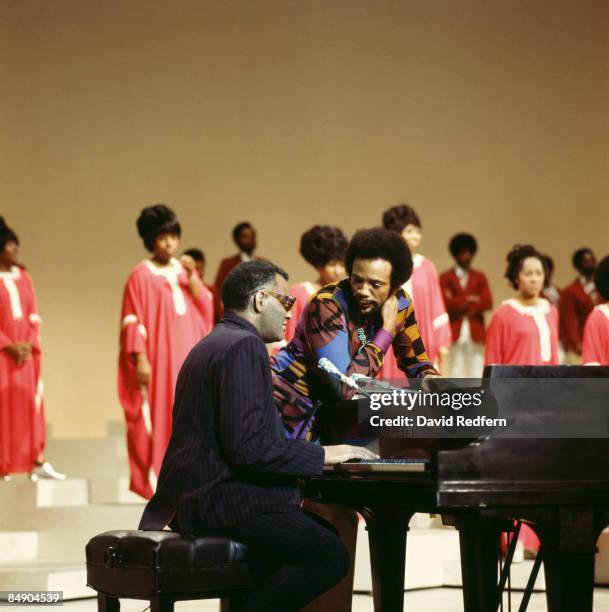 American singer, songwriter and pianist Ray Charles confers with producer Quincy Jones on stage during recording of the 'Duke Ellington...We Love You...