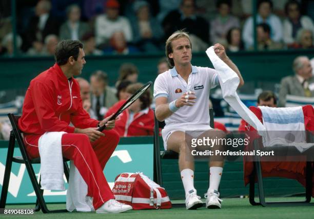 Paul Hutchins of Great Britain talking to John Lloyd during a break in play during a first round Davis Cup match against Australia in Adelaide, circa...