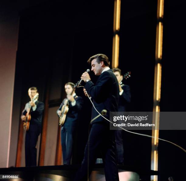 English singer Billy J. Kramer performs on stage with Robin MacDonald, Ray Jones and Mike Maxfield of The Dakotas on a television show circa 1964.