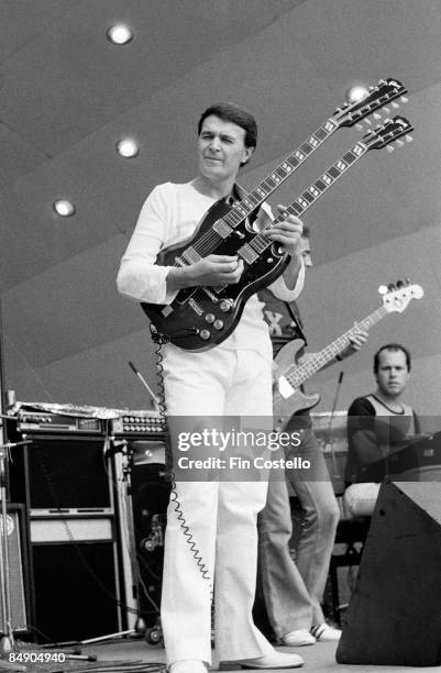 Photo of John McLAUGHLIN and MAHAVISHNU ORCHESTRA, John McLaughlin performing on stage, Gibson EDS-1275 twin necked guitar