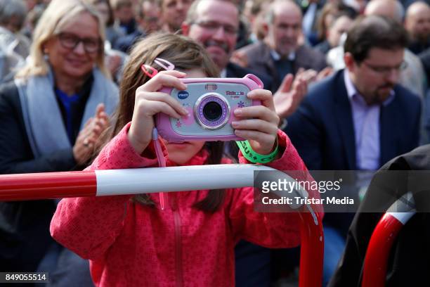Young photographer attends a campain of German chancellor Angela Merkel on September 18, 2017 in Regensburg, Germany.
