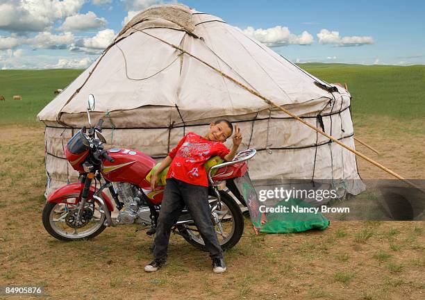 inner mongolian boy with motocycle infront of yurt - abagnar qi foto e immagini stock