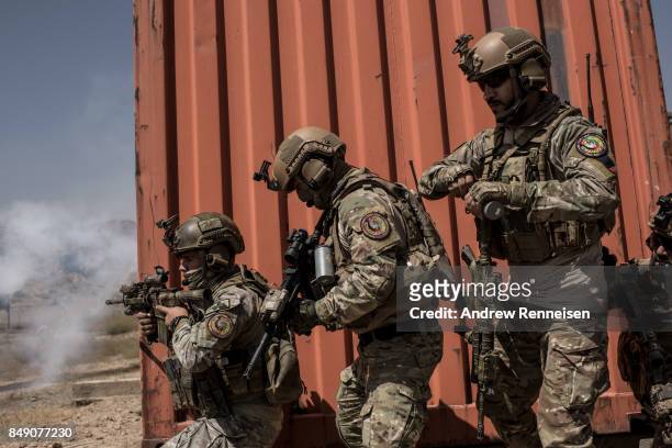 Members of Afghanistan's Crisis Response Unit 222, an Afghan Special Police Unit, participate in a training slowed down for the media on September 7,...