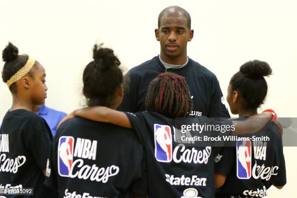 Chris Paul of the Houston Rockets interacts with kids during the NBA Cares Winston Salem State farm Assist Dedication event in Winston Salem, North...