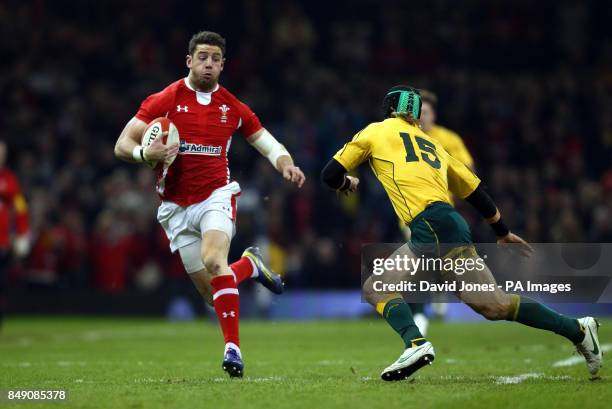 Wales' Alex Cuthbert tries to evade Australia's Berrick Barnes during the Dove Men Series match at the Millennium Stadium, Cardiff.