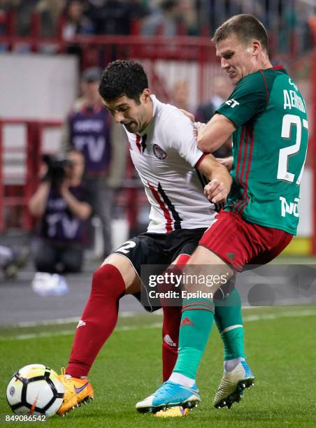 Igor Denisov of FC Lokomotiv Moscow vies for the ball with Alexander Milkovich of FC Amkar Perm during the Russian Premier League match between FC...