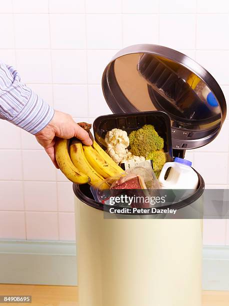 out of date food in garbage bin. - vuilnisbak stockfoto's en -beelden
