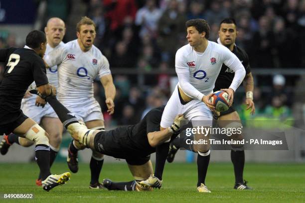 England's Ben Youngs offloads during the QBE International at Twickenham Stadium, London.