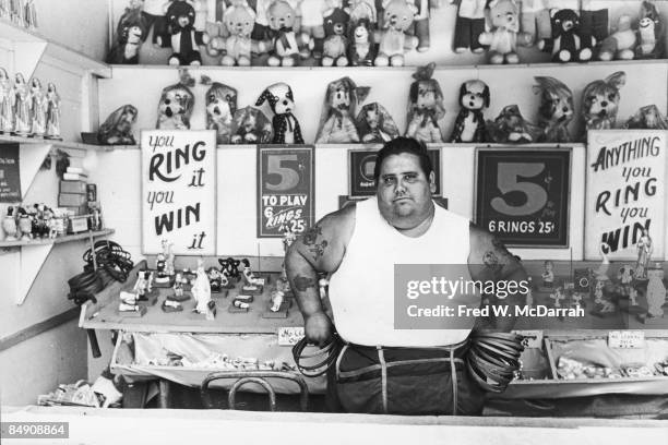 Portrait of the unidentified, tatooed operator of a 'ring toss' carnival game at Coney Island, Brooklyn, New York, June 13, 1965.