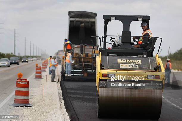 Road construction crews contracted by Parsons Brinckerhoff work on a widening project run by the Florida Department of Transportation on February 18,...