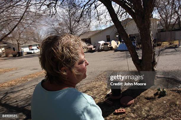 Sharon Wheeler looks on as furniture in piled in front of her neighbor's home after the tenant was evicted February 18, 2009 in Lafayette, Colorado....