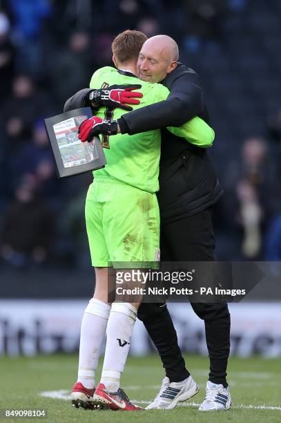 Milton Keynes Dons goalkeeper David Martin embraces goalkeeping coach Paul Heald after the final whistle