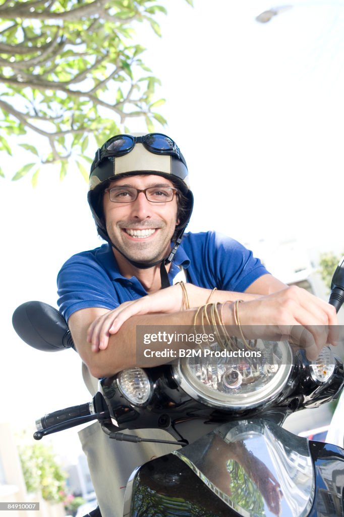 Man on scooter with helmet