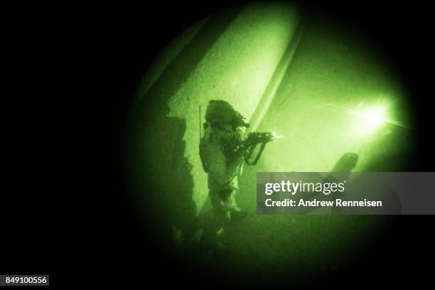 Member of the Afghan Special Forces is seen through a night vision goggle during casevac night training of Afghanistan Special Forces by the United...